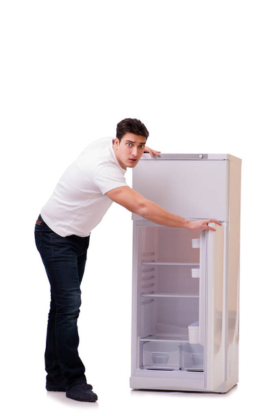 Man looking for food in empty fridge - Fotó, kép