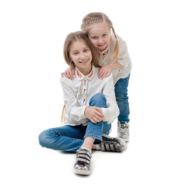Two sisters holding each other, isolated - Photo, image
