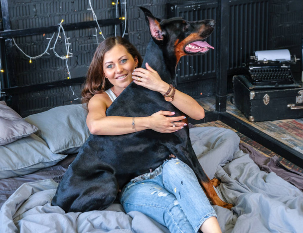 Woman in bed with big dog - Photo, Image