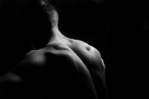Male fitness model showing muscles  - Valokuva, kuva