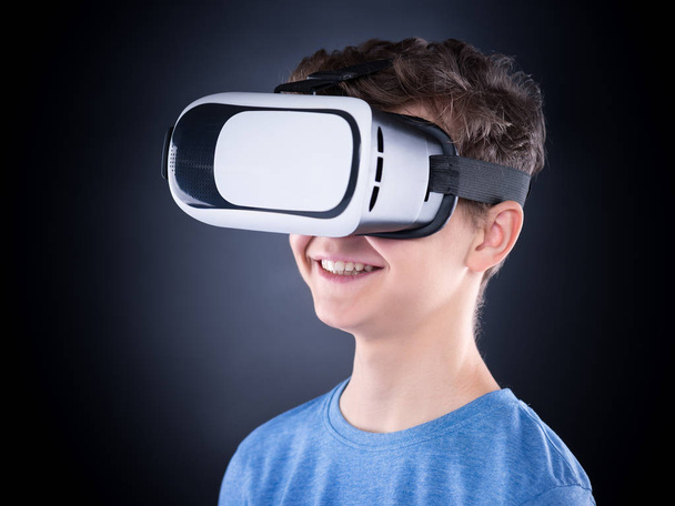 Teen boy in VR glasses - 写真・画像