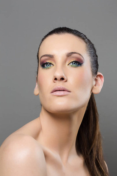 Head shot of a female model wearing birght make-up - Fotó, kép