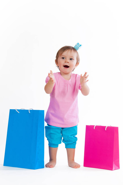 Sweet girl in pink and blue design with paper bags isolated on white background. - Foto, Imagem