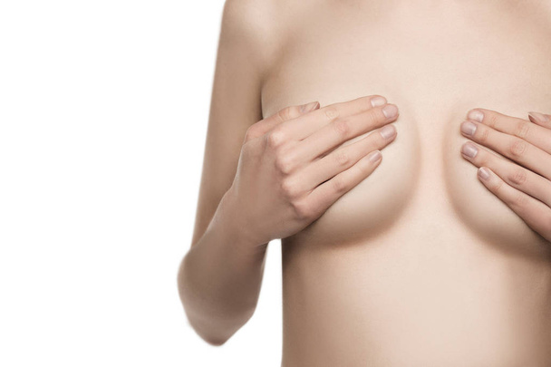 nude Female breast. Young caucasian adult woman examining her breast for lumps or signs of breast cancer - 写真・画像