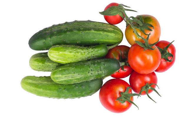 Tomatoes with cucumbers in a heap on white - Foto, afbeelding