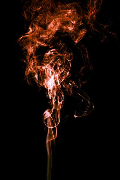 Abstract color smoke on black background, orange smoke backgroun - Photo, Image