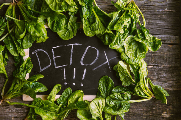 The inscription on the detox board and spinach around - Photo, Image