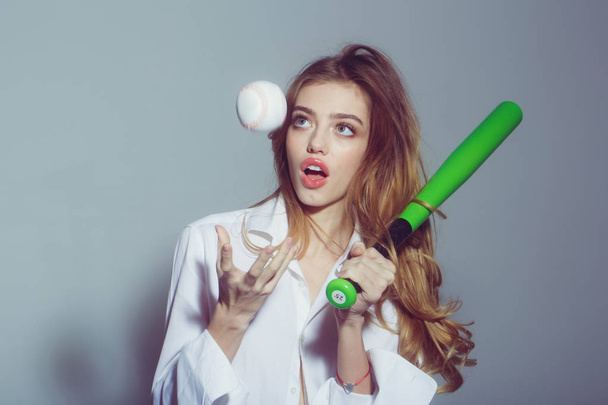 pretty sexy woman with long hair holds green baseball bat - Fotoğraf, Görsel