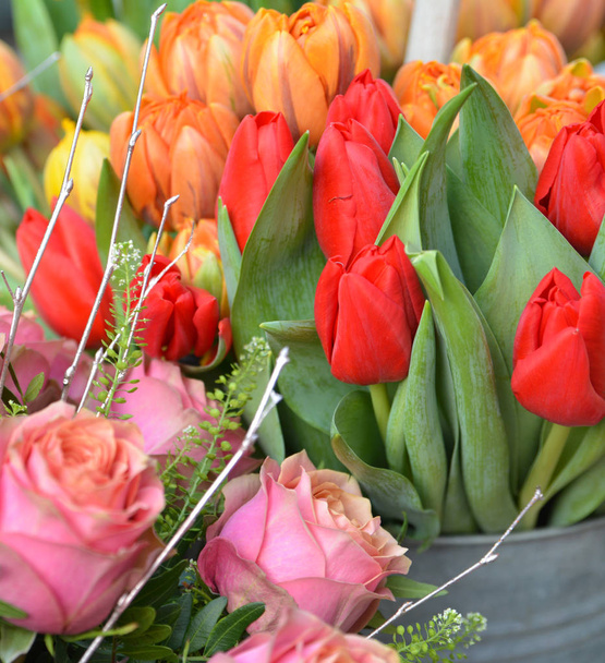 Orange and red tulips in a vase. Spring concept. - Foto, Bild