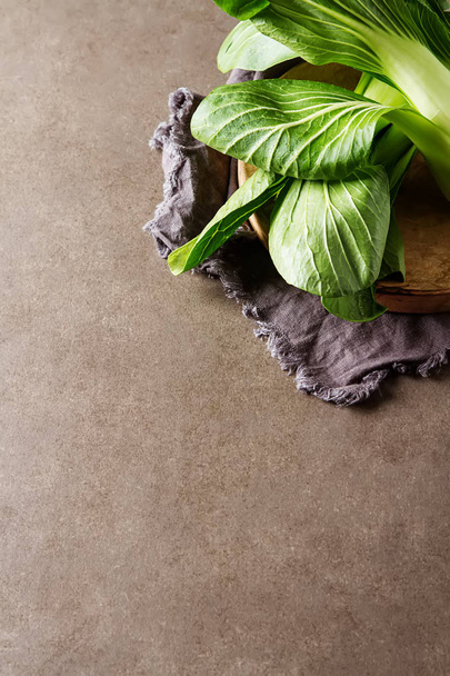 Overhead shot of Chinese cabbage, Bok Choy, on rustic background - Fotó, kép