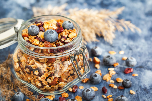 Homemade granola in jar and fresh blueberry - Photo, Image