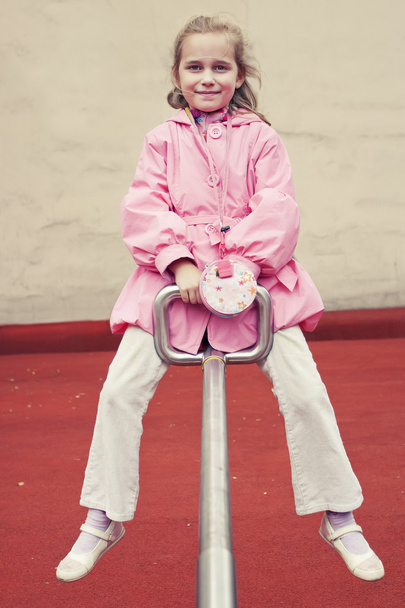 Little girl on a seesaw - Fotó, kép