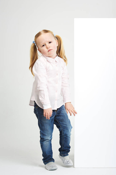 Beautiful little girl with white copy space on a white backgroun - Zdjęcie, obraz