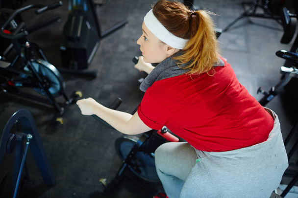 Woman working out on bicycle - Photo, Image