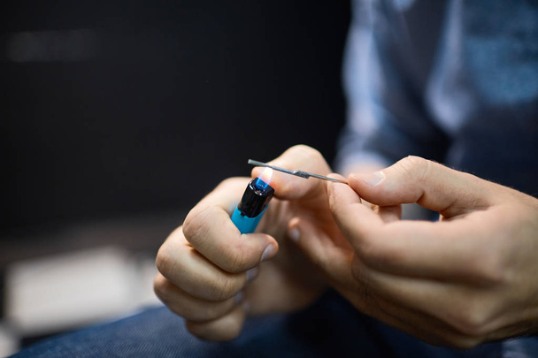 Tattooer disinfecting needle - Photo, Image