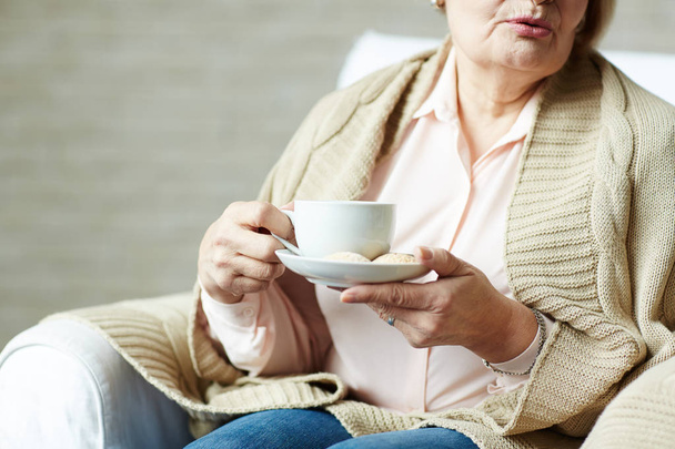 Elderly woman with cup of tea - Фото, зображення