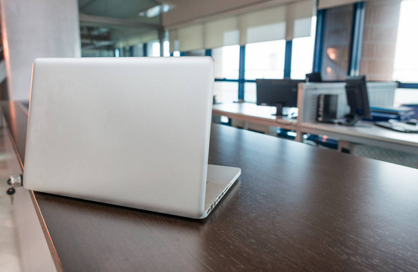 Laptop on a modern office interior - 写真・画像