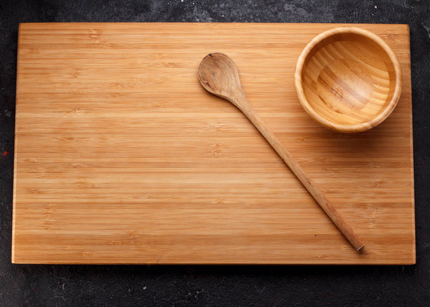 Wooden dishes over dark concrete background - Zdjęcie, obraz