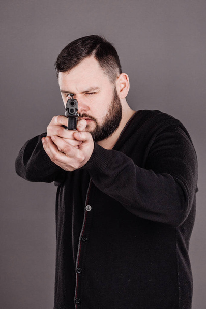 man with pistol. dangerous and criminal   - Foto, afbeelding
