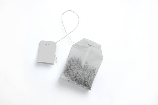Teabag with grey label. Top view. Isolated on a white. mockup - Φωτογραφία, εικόνα