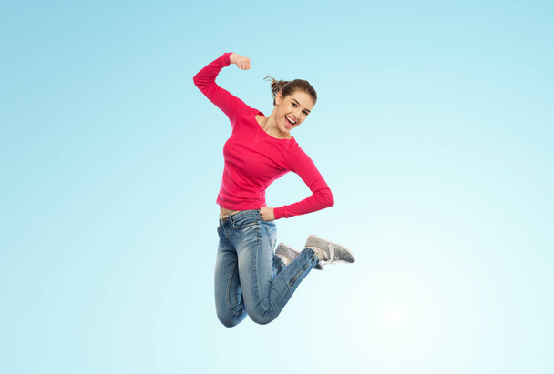 smiling young woman jumping in air - Valokuva, kuva