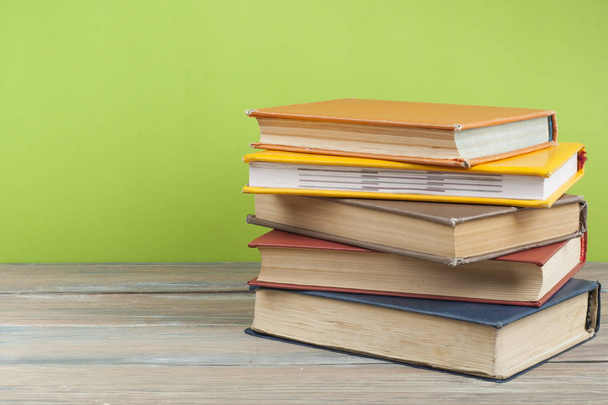 Stack of colorful books on wooden desk, free copy space. Back to school. Education background - Foto, immagini