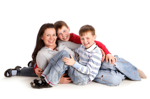 Two Sons Sit next to their mother on the White Background  - Photo, image