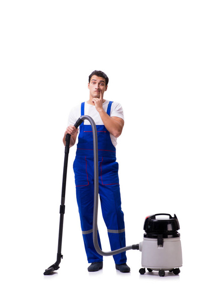 Man in coveralls doing vacuum cleaning on white - Fotoğraf, Görsel