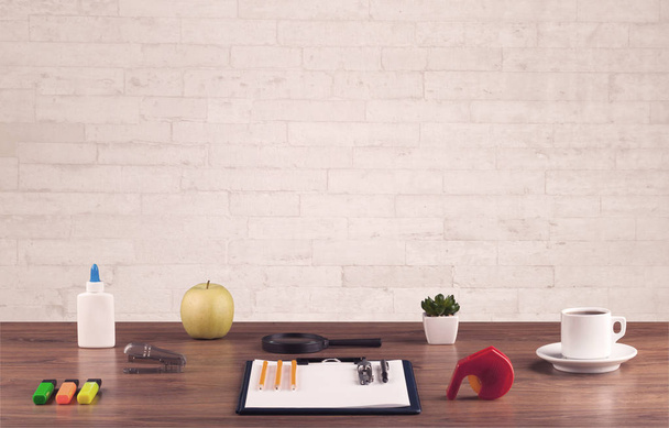 Office desk closeup with white brick wall - Fotografie, Obrázek