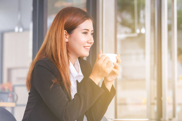 beautiful young business woman drinking coffee  - Photo, image