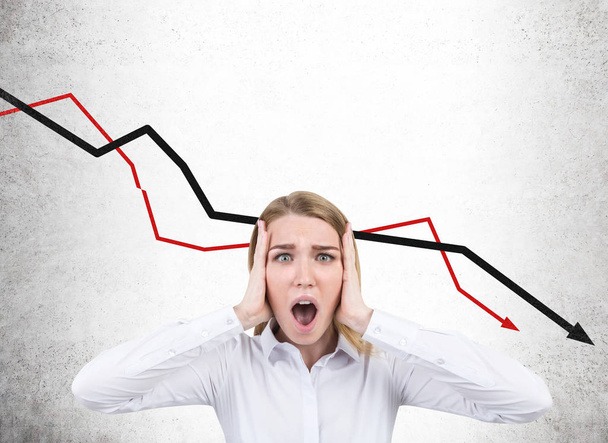 Stressed businesswoman and falling graphs - Фото, изображение