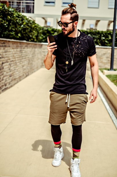 Hipster parrakas mies urheiluvaatteet kävely ja matkapuhelimella
 - Valokuva, kuva