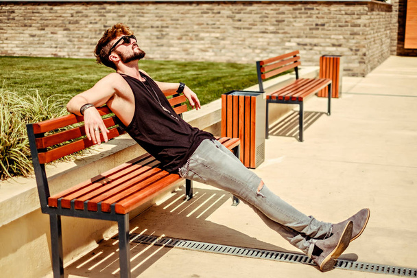 Hipster bearded man thinking and resting on the bench - Photo, Image