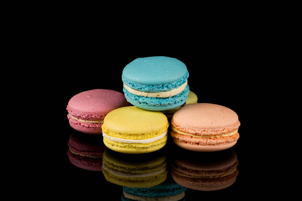 Colorful pink macaroon over a black background - Foto, Imagen