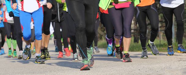ryhmä miesten ja naisten juoksijoita urheilutapahtuman aikana
 - Valokuva, kuva