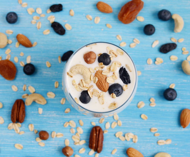 Vitamin breakfast yogurt cocktail and nuts in glass - Fotó, kép