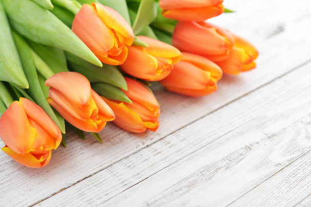 Red tulips on wooden background - Zdjęcie, obraz