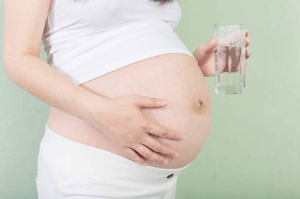 fiatal szép a terhes nő, üveg - Fotó, kép