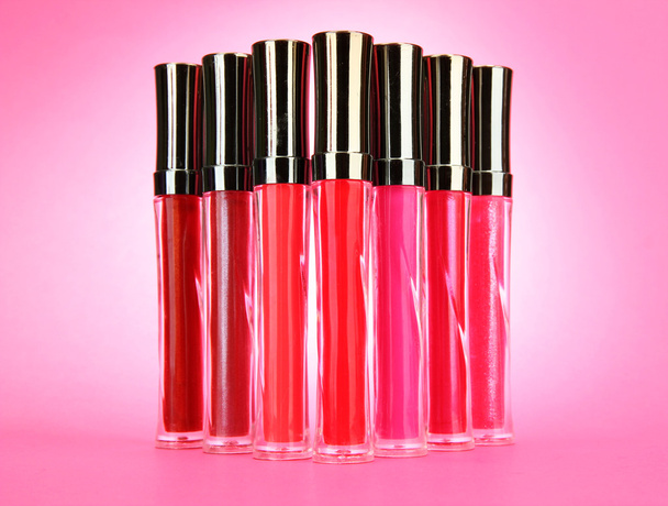 beautiful lip glosses, on pink background - Fotó, kép