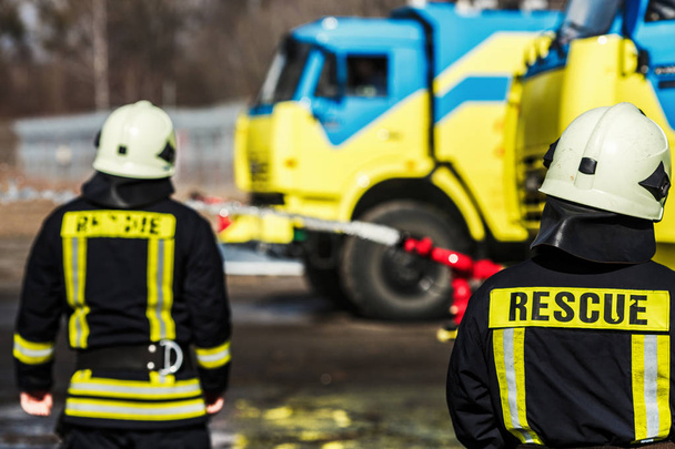 Firefighters fighting fire during training - Fotoğraf, Görsel