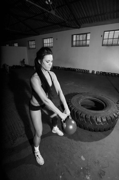 Woman doing kettle bell excercise - Photo, image