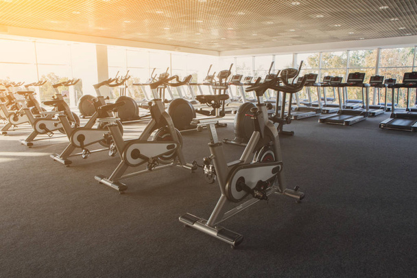 Modern gym interior with equipment, fitness exercise bikes - Foto, Imagen