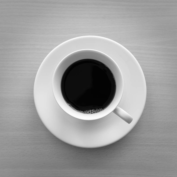 Top view of a cup of hot coffee on wooden table. back and white  - Фото, изображение