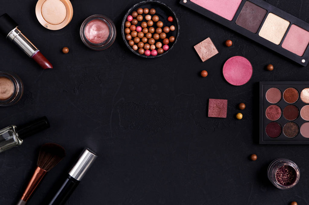 Makeup cosmetics essentials frame black background, copy space - Photo, Image