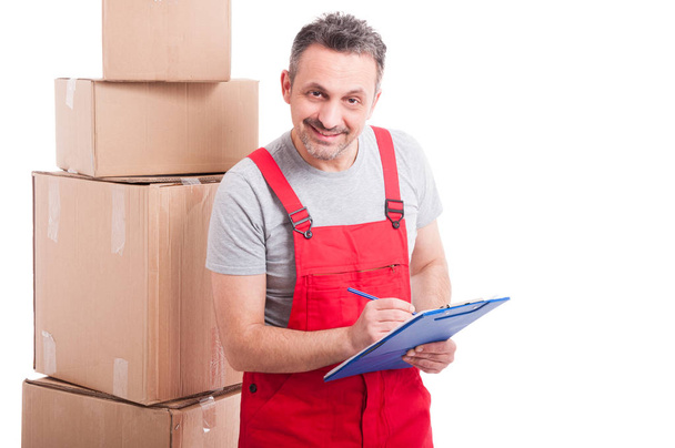 Mover guy smiling and counting or writing on clipboard - Photo, Image