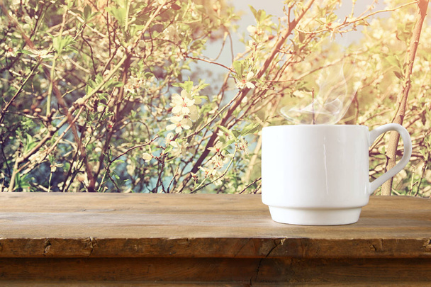 Cup of coffee a wooden table - Фото, зображення