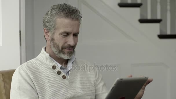 Mature adult male working on digital tablet - Metraje, vídeo
