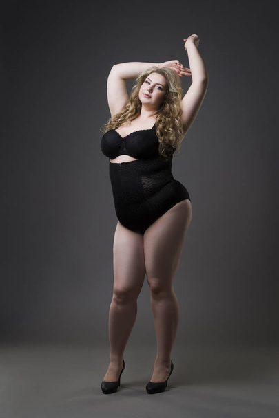 Young beautiful blonde plus size model in shapewear, xxl woman in slimming underwear on gray studio background - Foto, Imagem