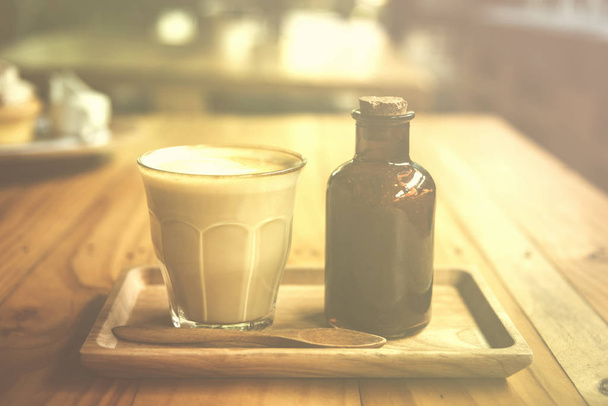 vintage art filter image of coffee latte art in cafe - Fotó, kép