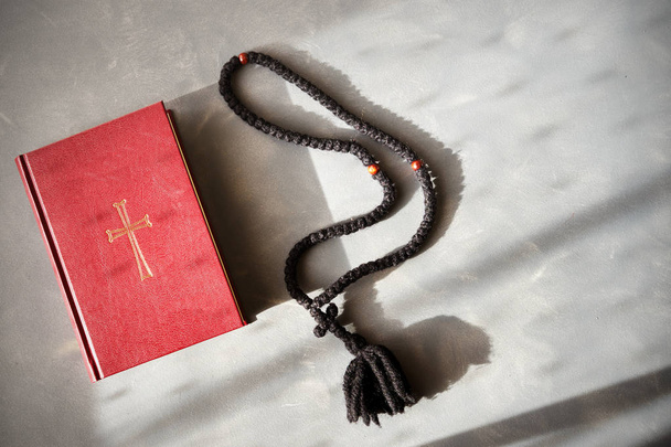 Bible and rosary on a cement background. - Valokuva, kuva